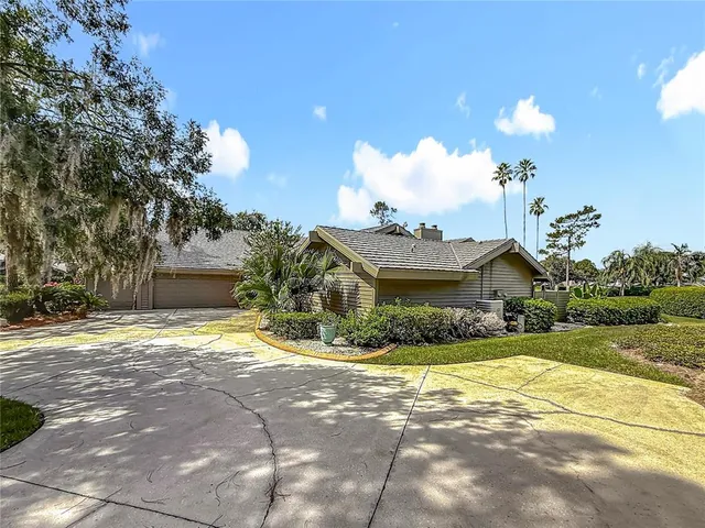 a view of a house with a door and a tree