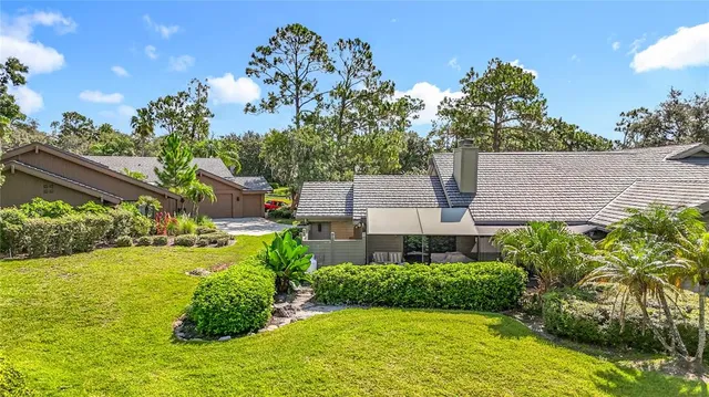 a backyard of a house with barbeque oven table and chairs
