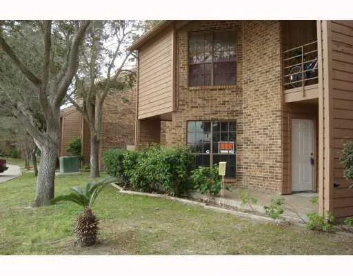 a backyard of a house with a garden and outdoor seating