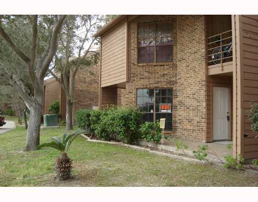 7122 Premont Drive, Unit 101F Corpus Christi, TX 78414 - Photo 1 of 8 a backyard of a house with a garden and outdoor seating