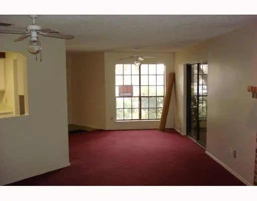 a view of a big room with windows and chandelier