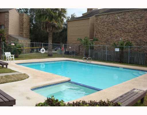 7122 Premont Drive, Unit 101F Corpus Christi, TX 78414 - Photo 7 of 8 a view of a swimming pool with a yard