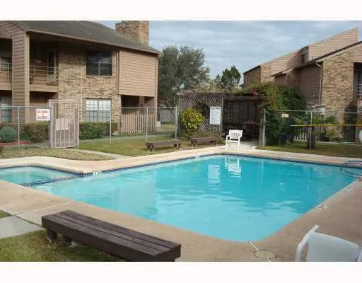 a swimming pool view with a outdoor seating