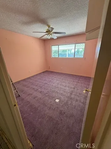 a view of an empty room and a window