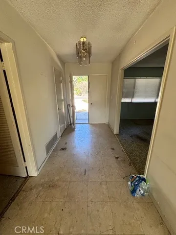 a view of entryway with kitchen