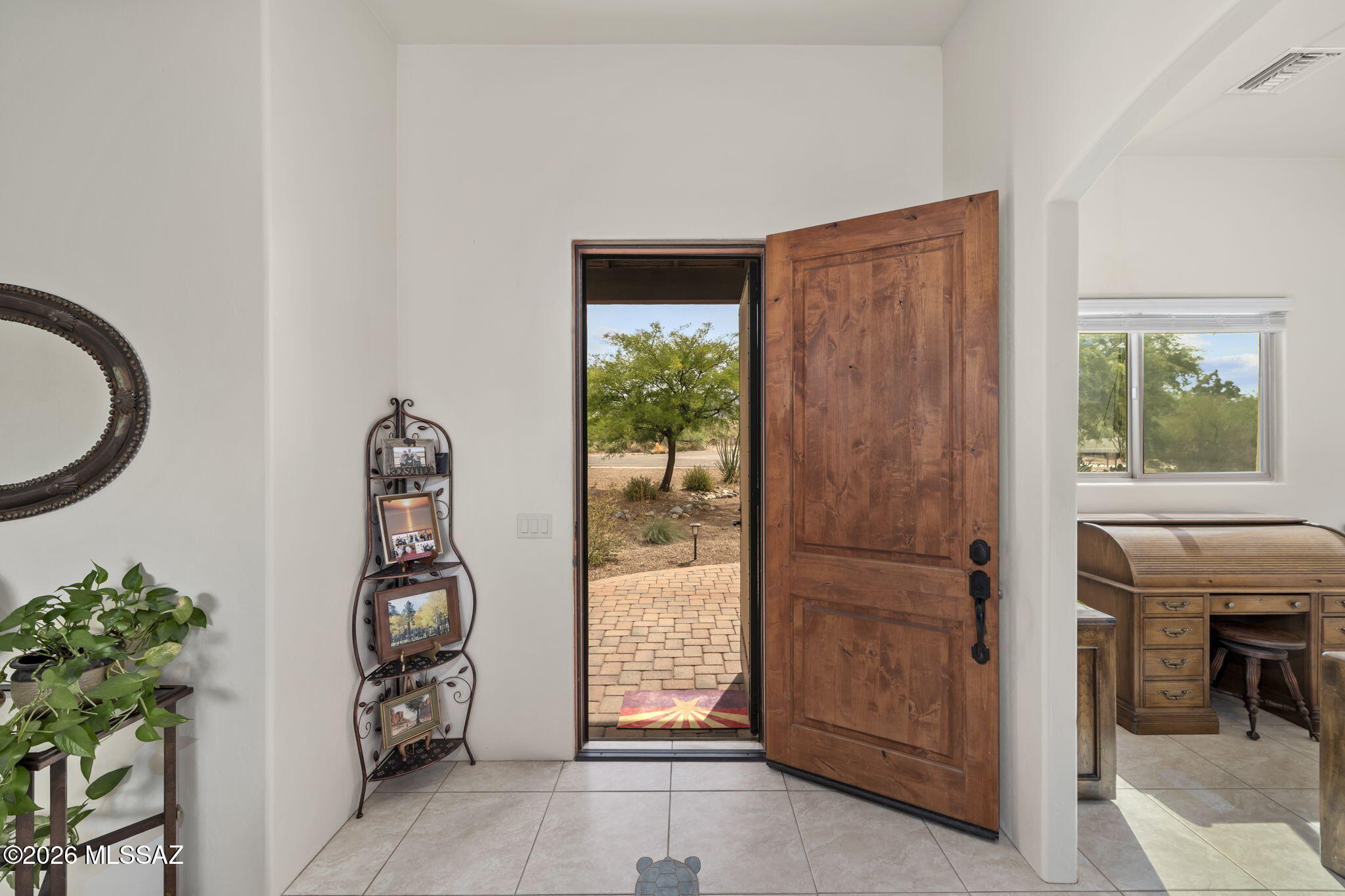 45 High View Court Tubac, AZ 85646 - Photo 10 of 44 an entryway with a flower pot and a window