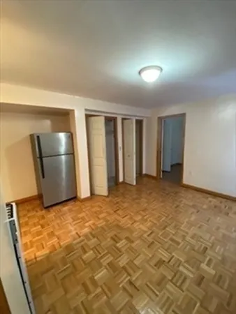 a view of an empty room with a kitchen