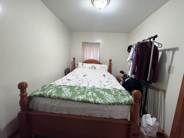 a bedroom with a bed and dresser