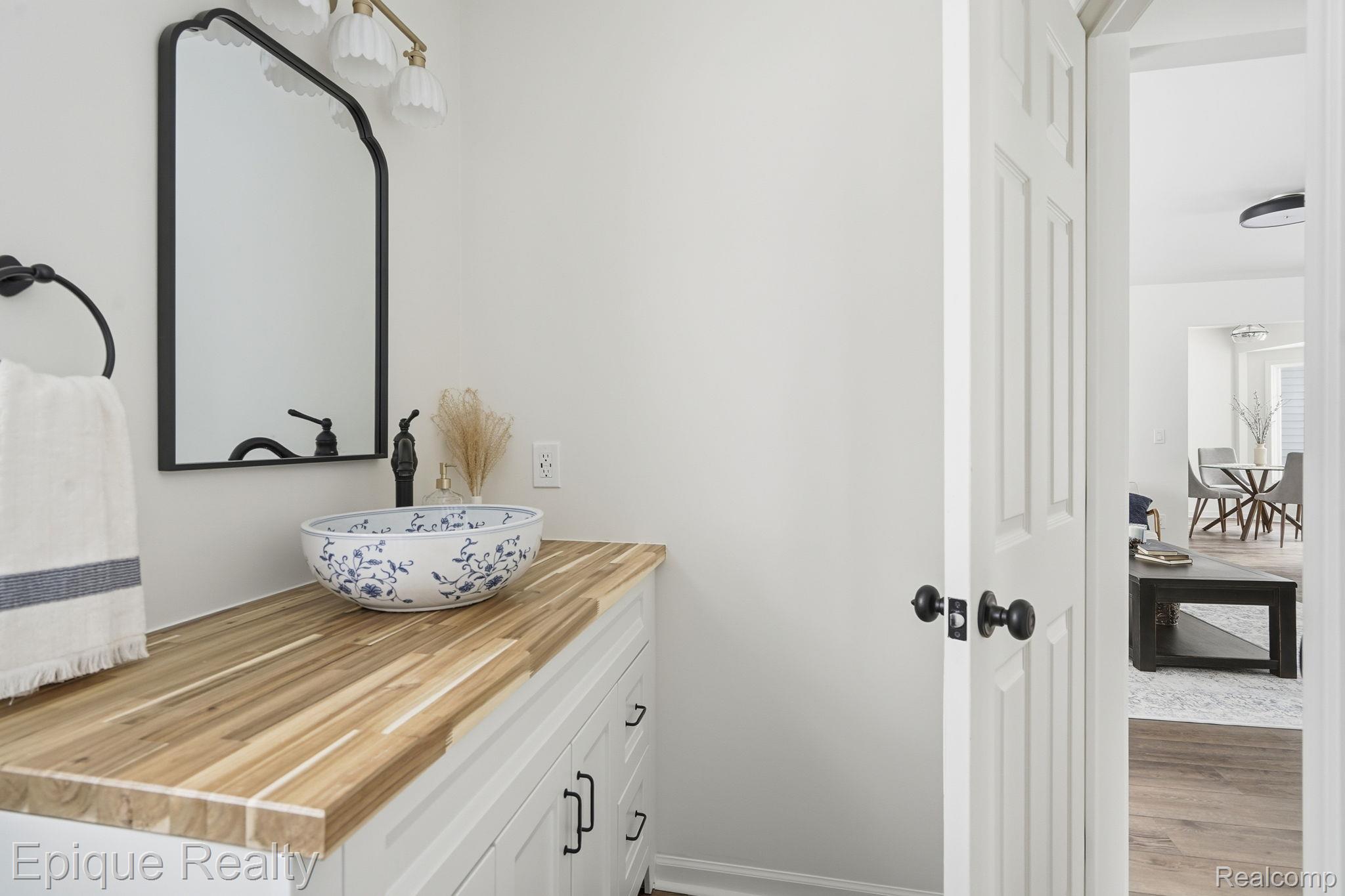 8680 Oakhill Road Clarkston, MI 48348 - Photo 11 of 52 Bathroom with vanity and wood finished floors