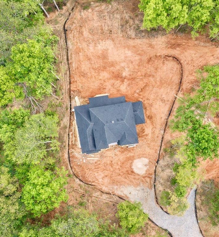 1290 New Hope Church Road Monroe, GA 30656 - Photo 2 of 3 a backyard of a house with large trees and plants