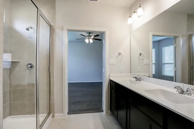 a bathroom with a double vanity sink a and mirror