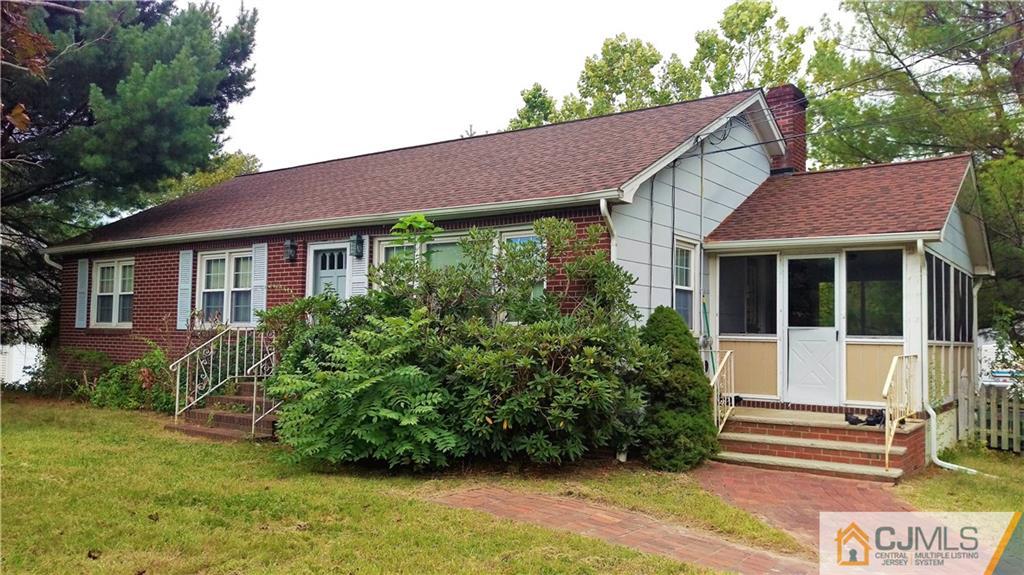 333 Amboy Road Old Bridge, NJ 07747 - Photo 1 of 17 a view of a house with a yard plants and large tree