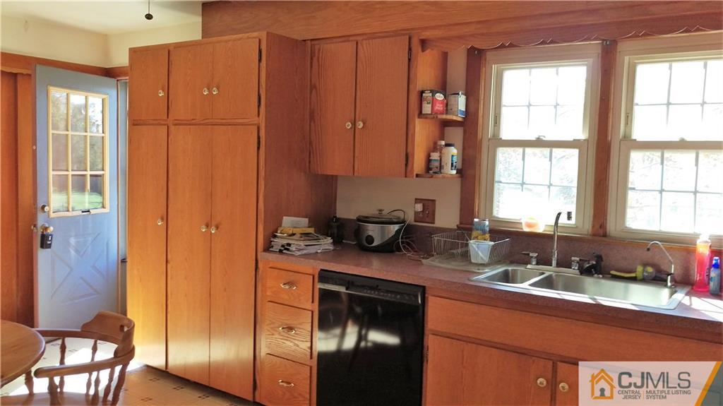 333 Amboy Road Old Bridge, NJ 07747 - Photo 4 of 17 a kitchen with stainless steel appliances granite countertop a sink stove and cabinets