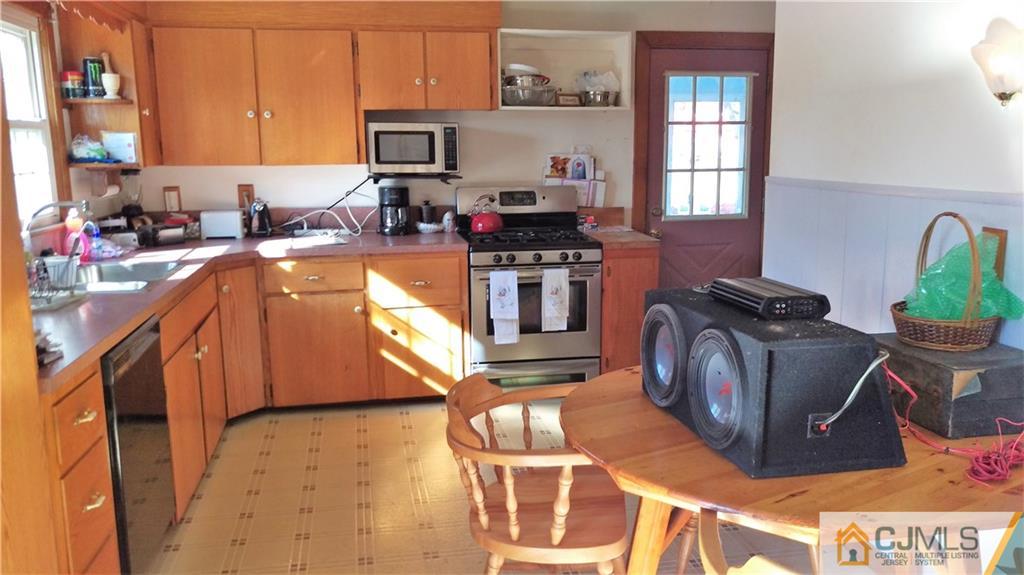 333 Amboy Road Old Bridge, NJ 07747 - Photo 5 of 17 a kitchen with granite countertop a stove and a refrigerator
