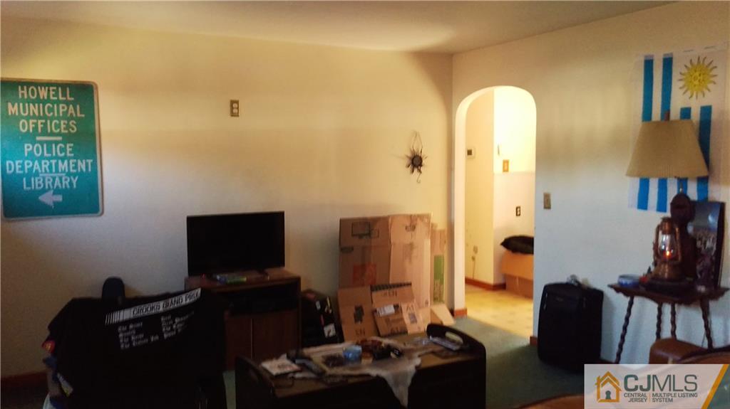 333 Amboy Road Old Bridge, NJ 07747 - Photo 7 of 17 a living room with furniture and a flat screen tv