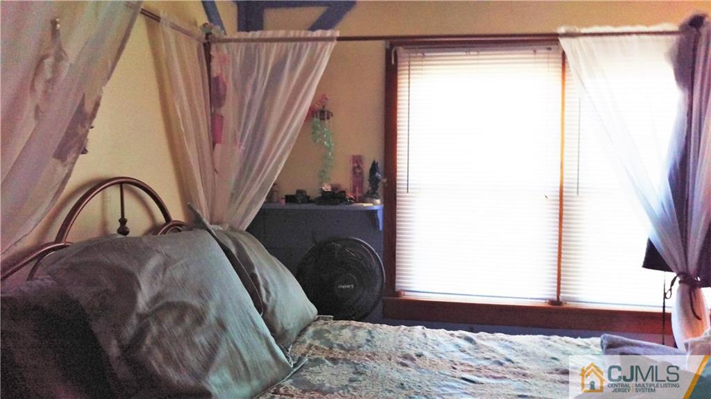 333 Amboy Road Old Bridge, NJ 07747 - Photo 9 of 17 a bedroom with a bed and a window