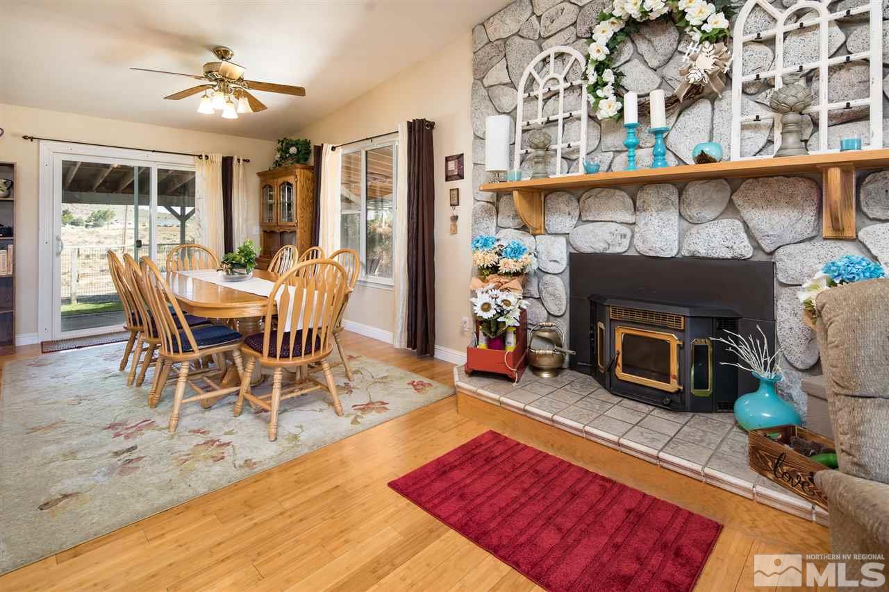 10385 Placerville Road Reno, NV 89508 - Photo 11 of 25 a dining room with furniture a fireplace and wooden floor