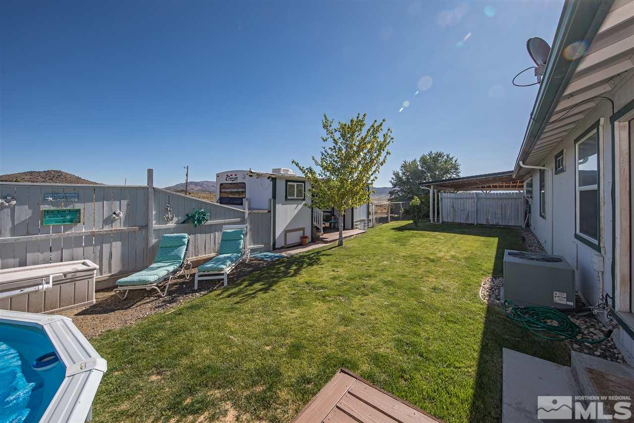 10385 Placerville Road Reno, NV 89508 - Photo 21 of 25 a blue swimming pool with outdoor seating and yard