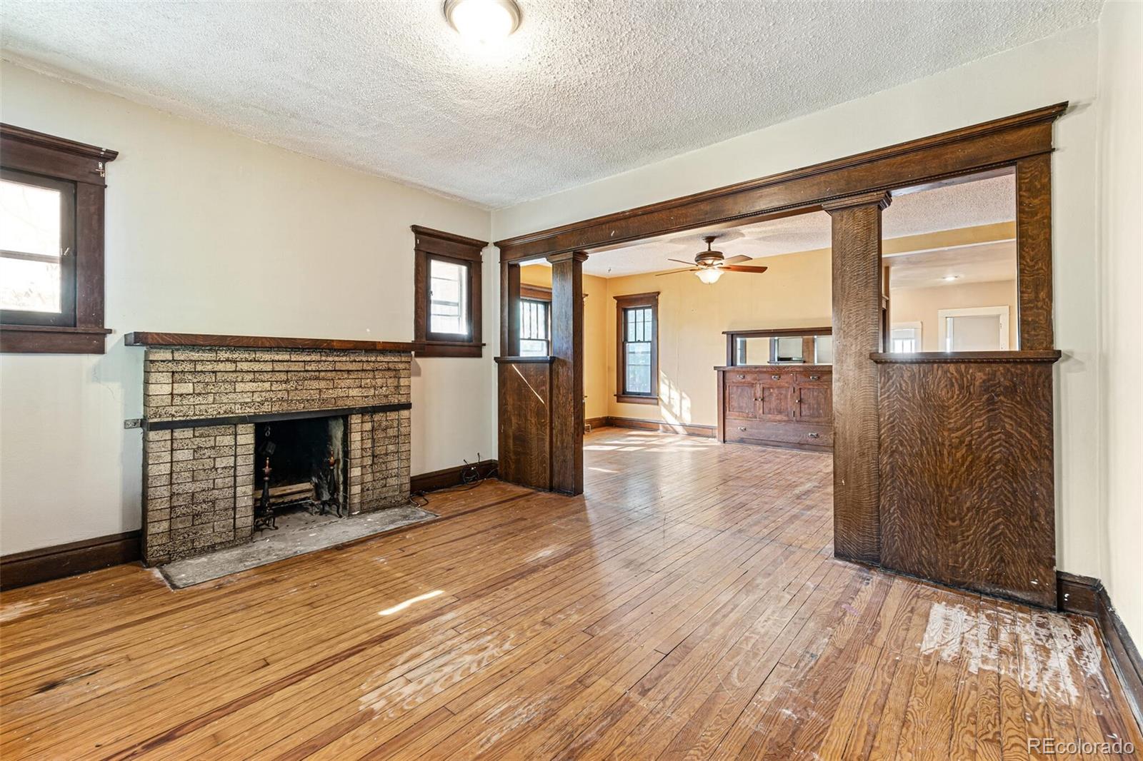 2089 South Logan Street Denver, CO 80210 - Photo 16 of 41 wooden floor fireplace and windows in an empty room