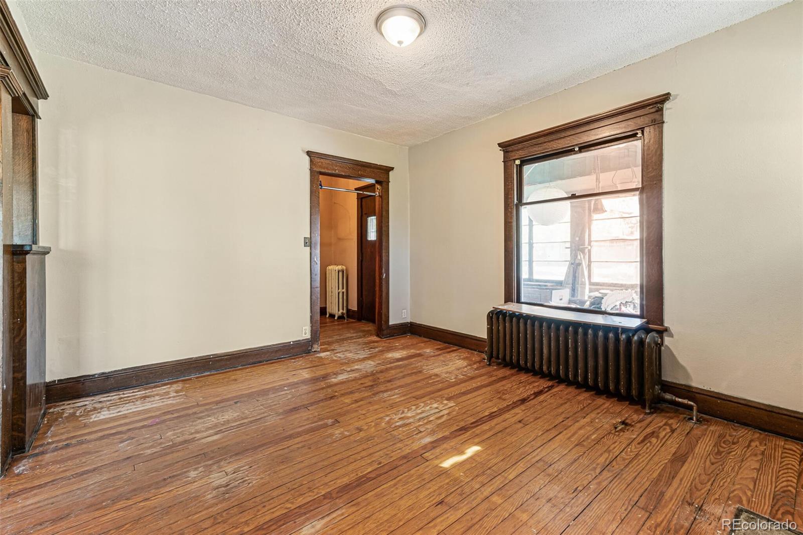 2089 South Logan Street Denver, CO 80210 - Photo 17 of 41 a view of an empty room with wooden floor and a window