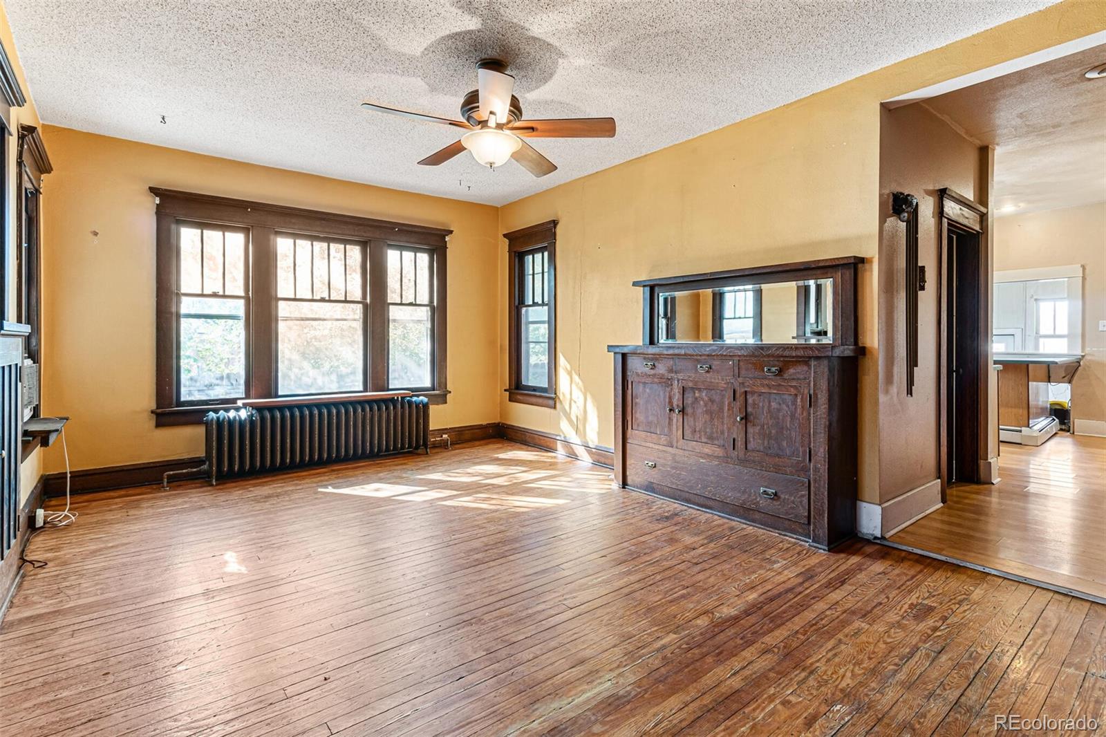 2089 South Logan Street Denver, CO 80210 - Photo 18 of 41 a view of an empty room with window and wooden floor