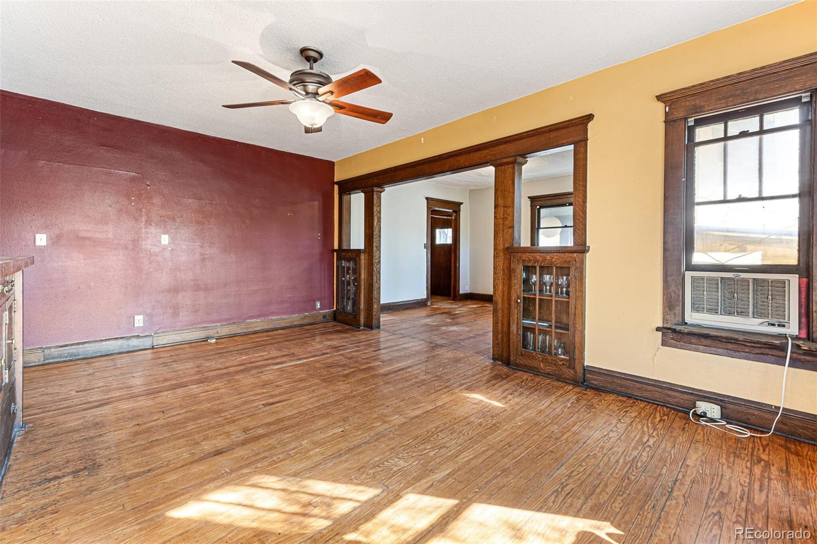 2089 South Logan Street Denver, CO 80210 - Photo 19 of 41 a view of an empty room with wooden floor and a window