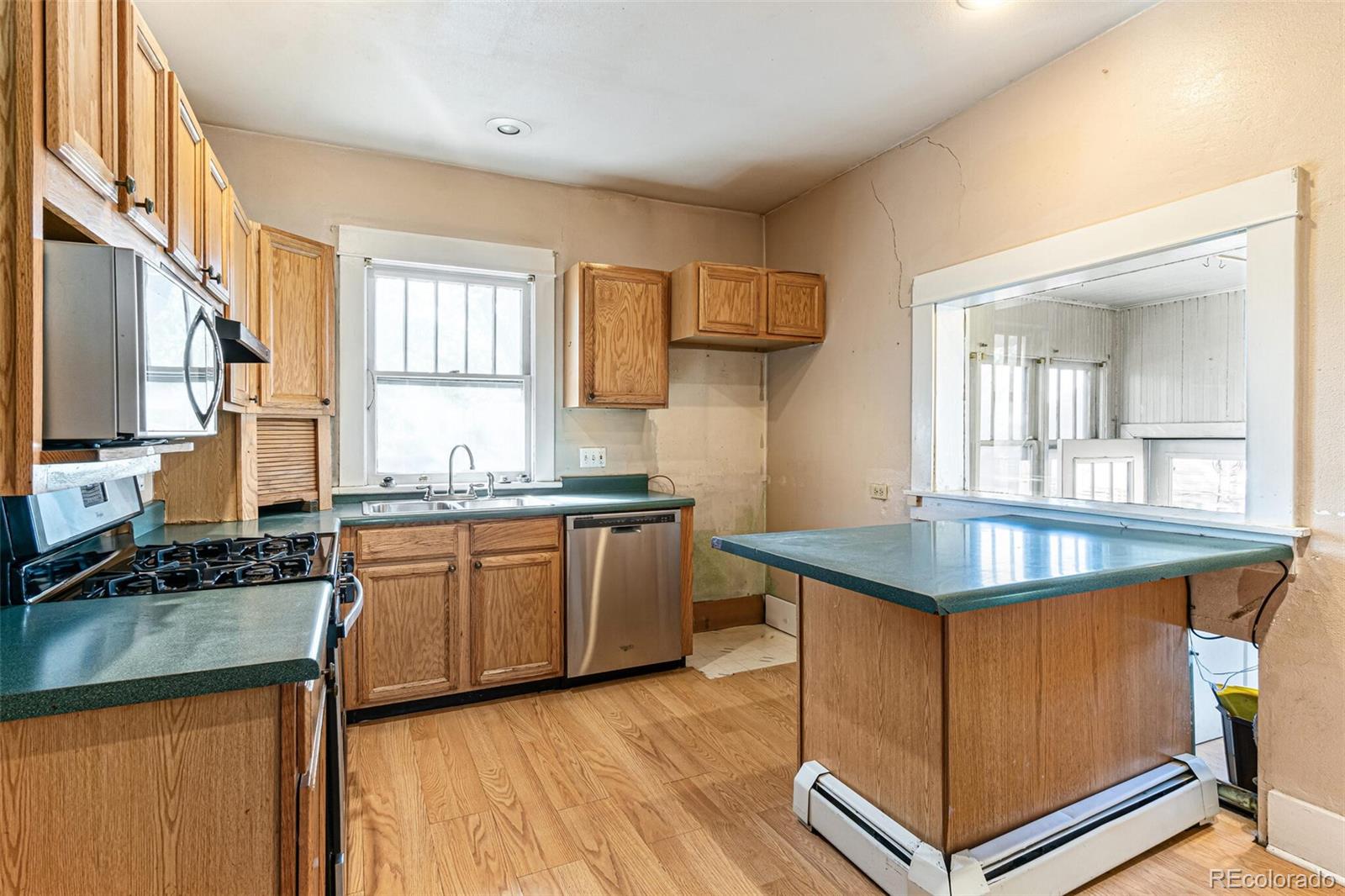 2089 South Logan Street Denver, CO 80210 - Photo 20 of 41 a kitchen with granite countertop a sink stove and cabinets