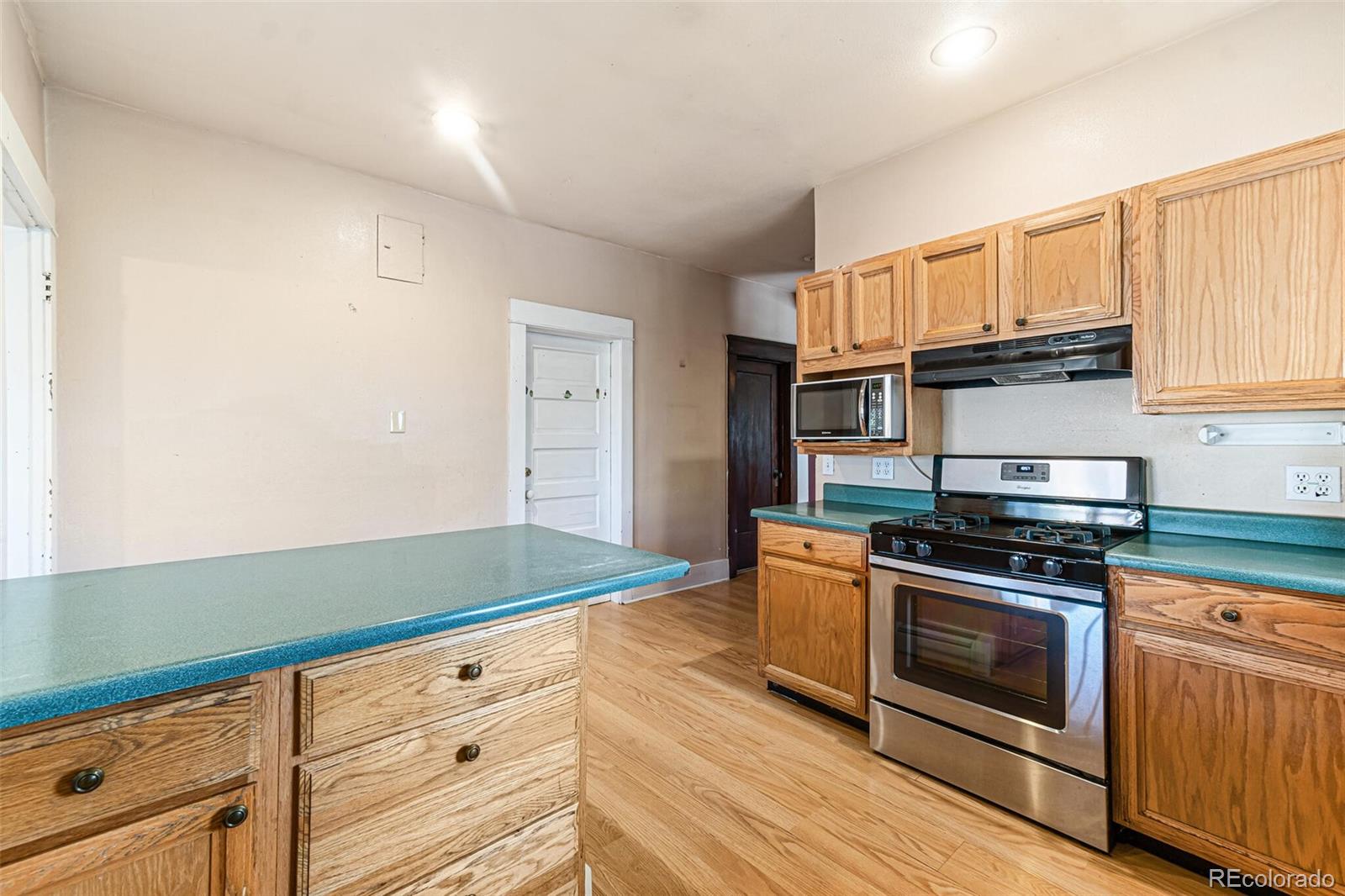 2089 South Logan Street Denver, CO 80210 - Photo 21 of 41 a kitchen with granite countertop a stove and a sink