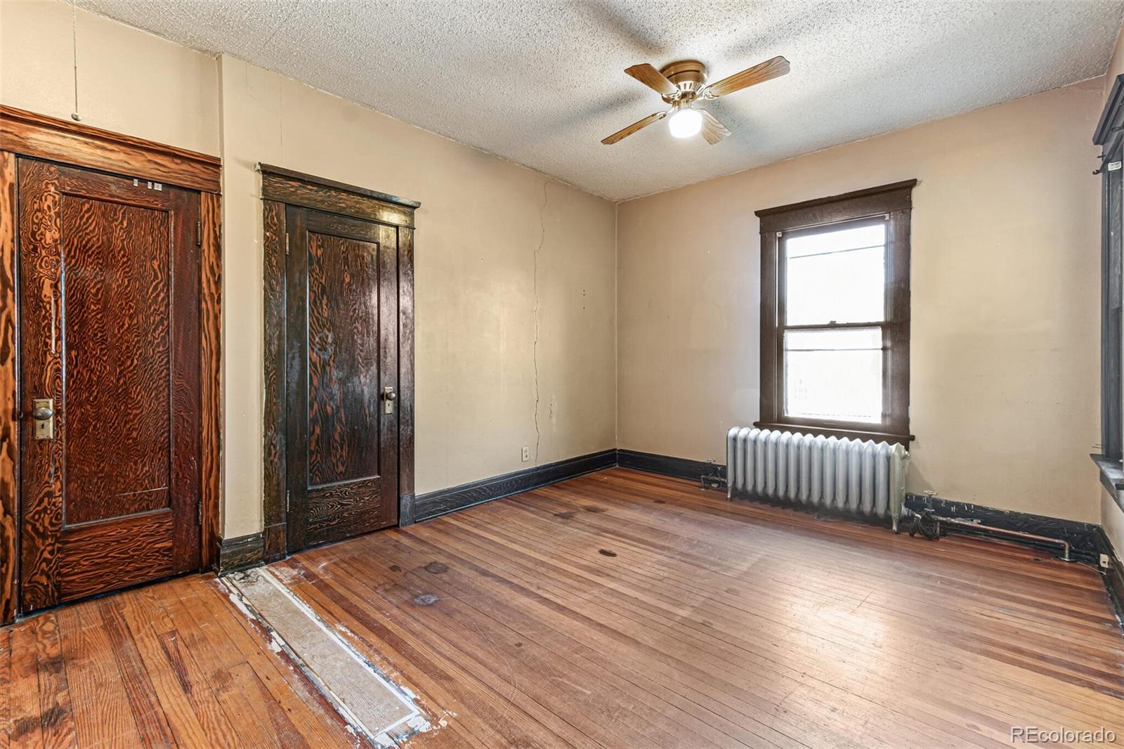 2089 South Logan Street Denver, CO 80210 - Photo 23 of 41 an empty room with windows and ceiling fan