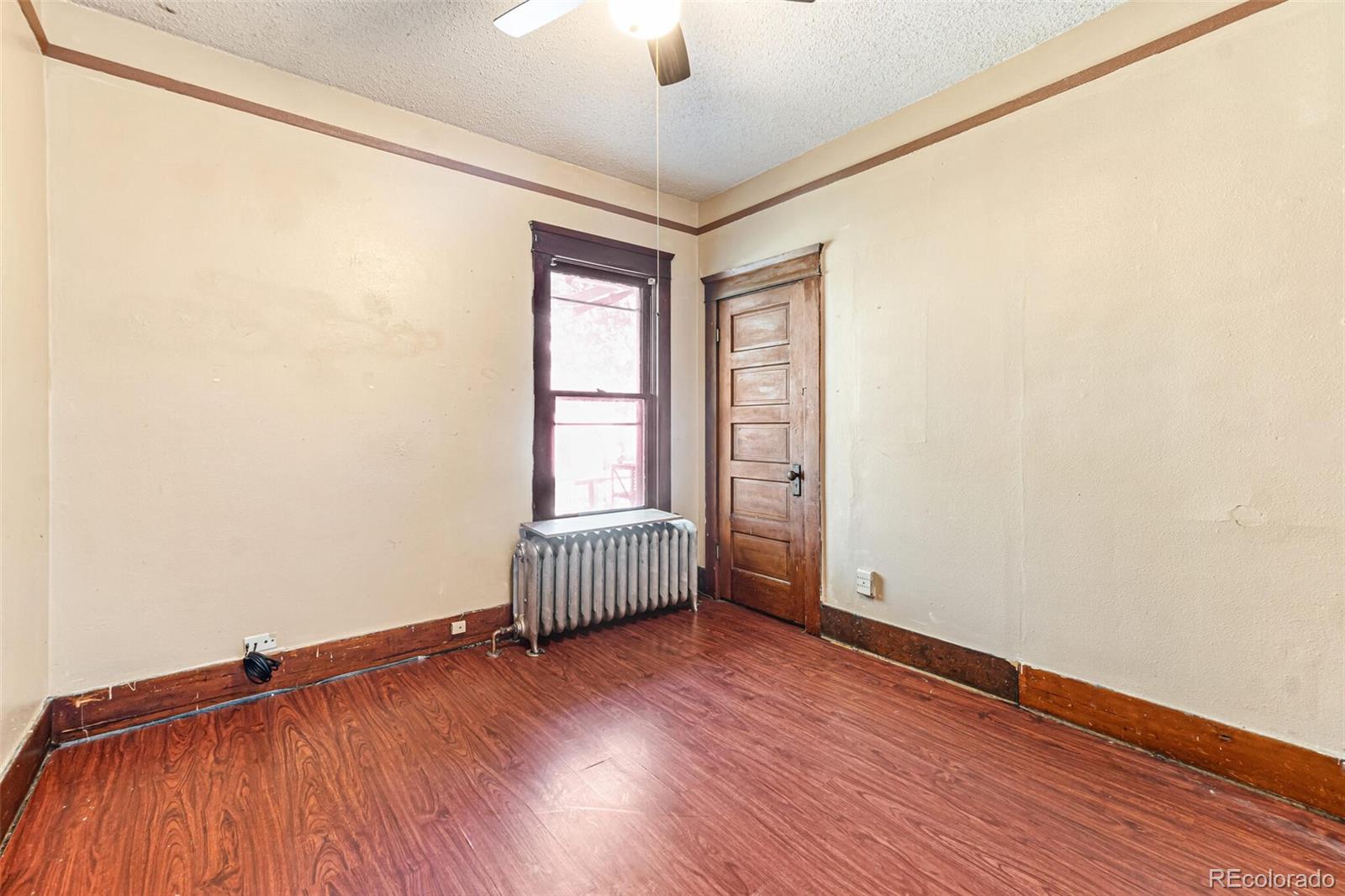 2089 South Logan Street Denver, CO 80210 - Photo 25 of 41 an empty room with windows and ceiling fan