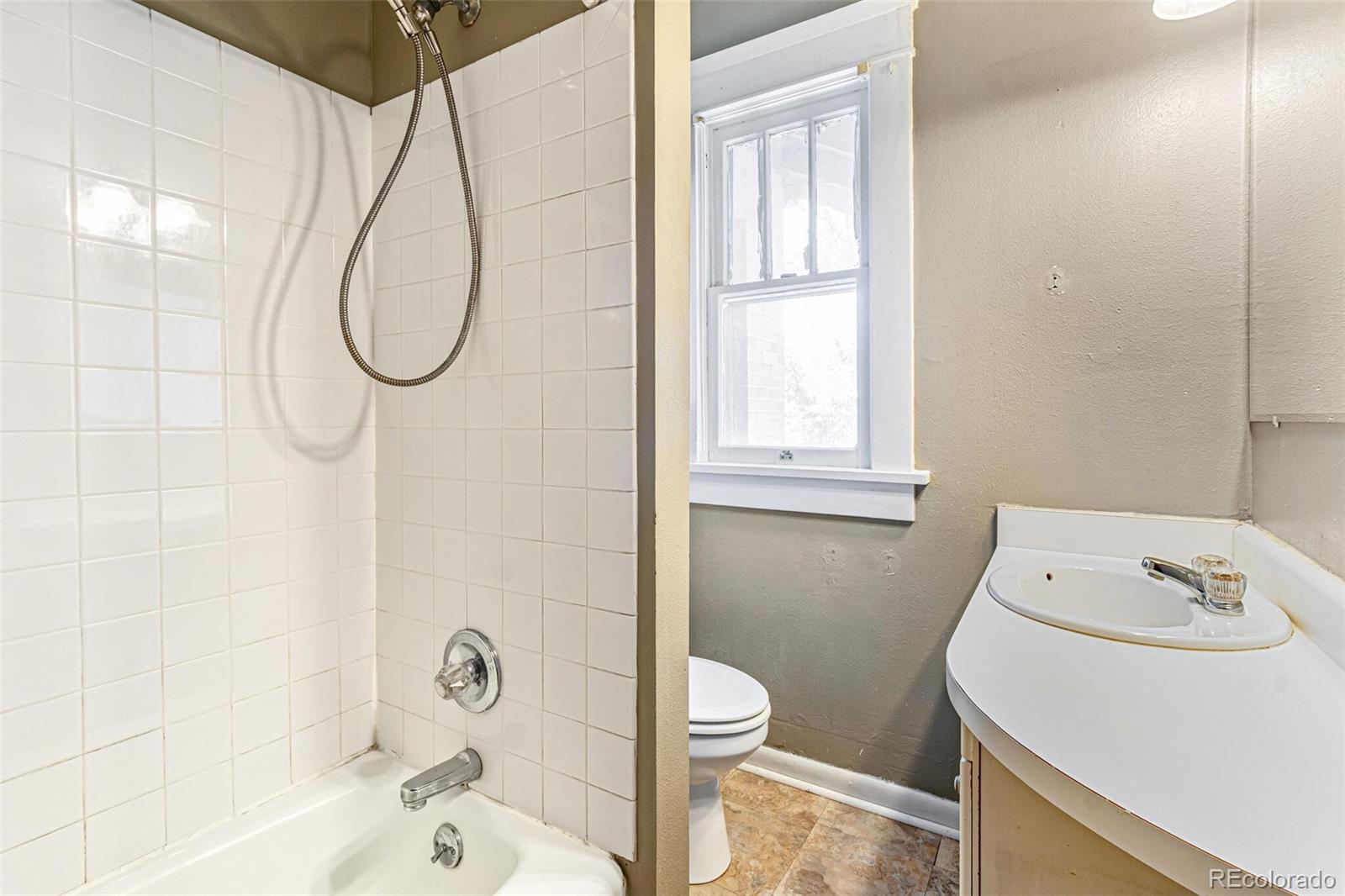2089 South Logan Street Denver, CO 80210 - Photo 26 of 41 a bathroom with a sink a toilet and shower