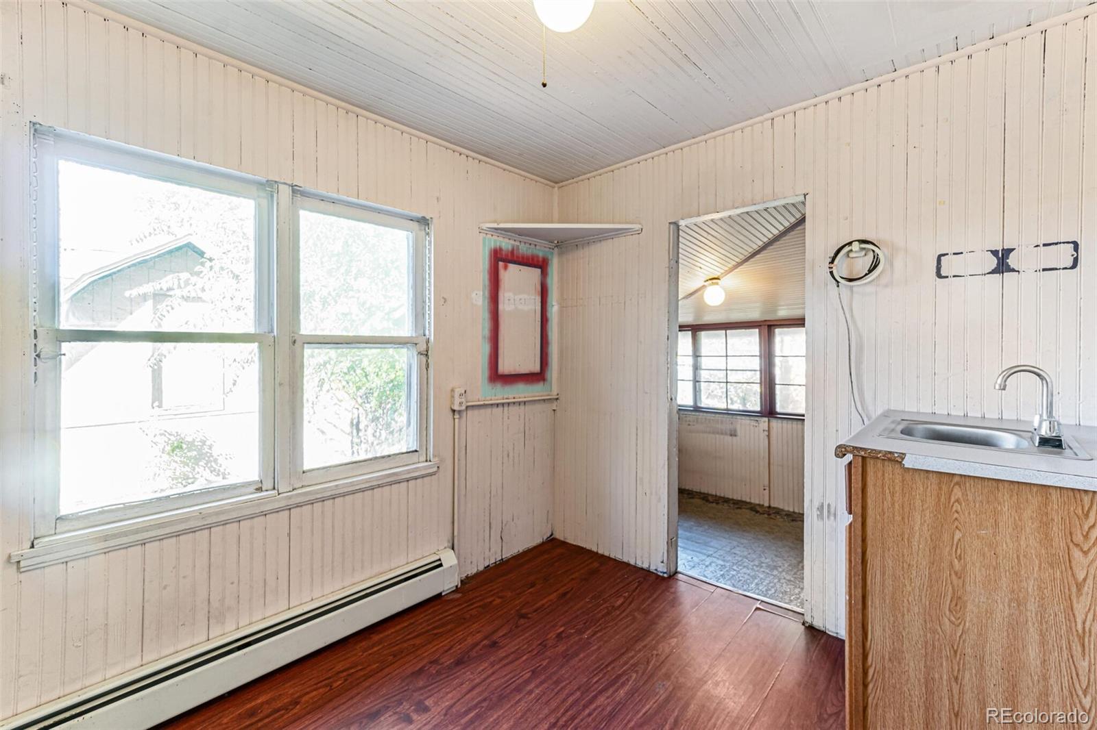 2089 South Logan Street Denver, CO 80210 - Photo 28 of 41 a view of a livingroom with wooden floor and a window