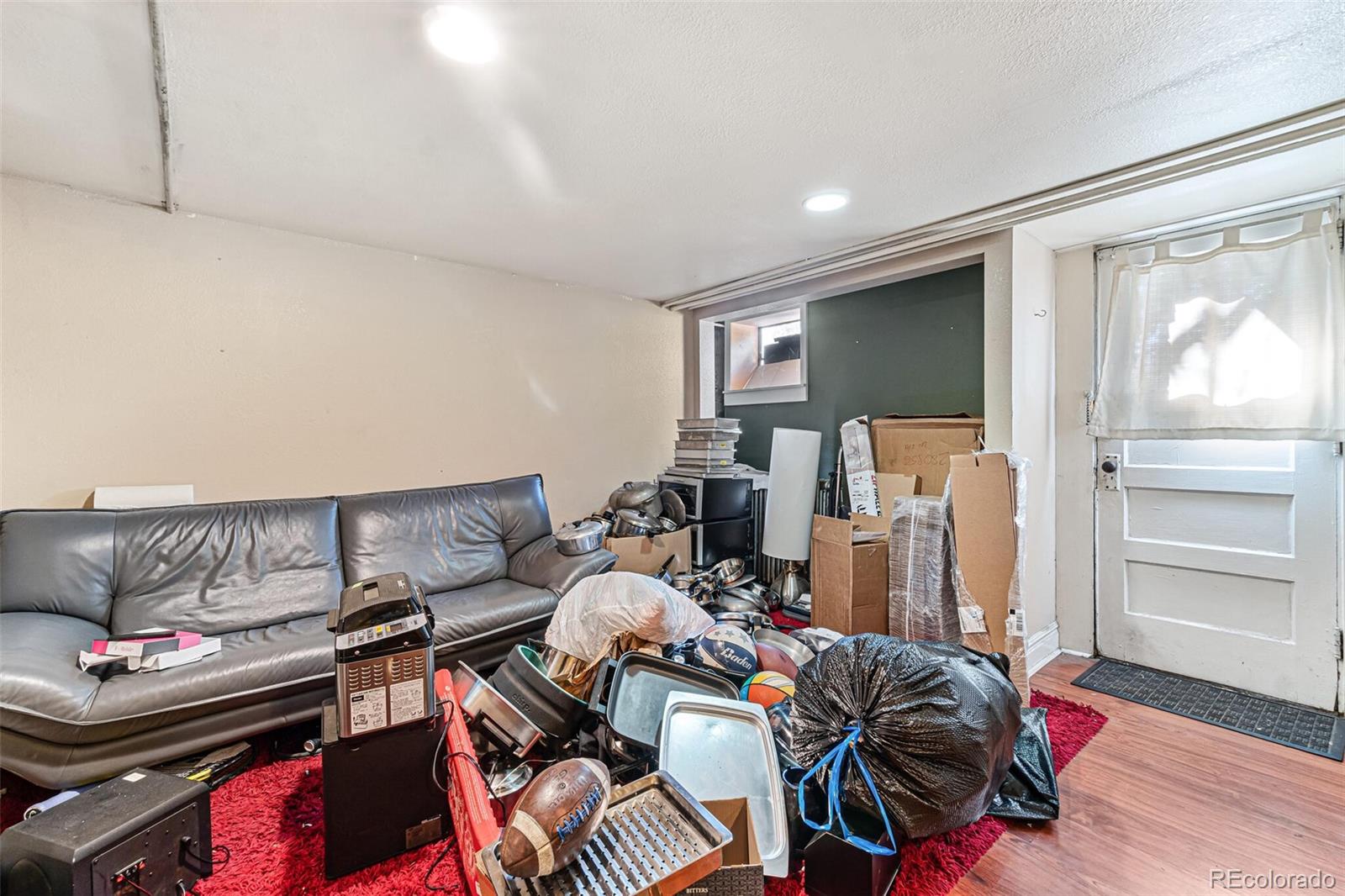 2089 South Logan Street Denver, CO 80210 - Photo 30 of 41 a bed room with a bed and a couch