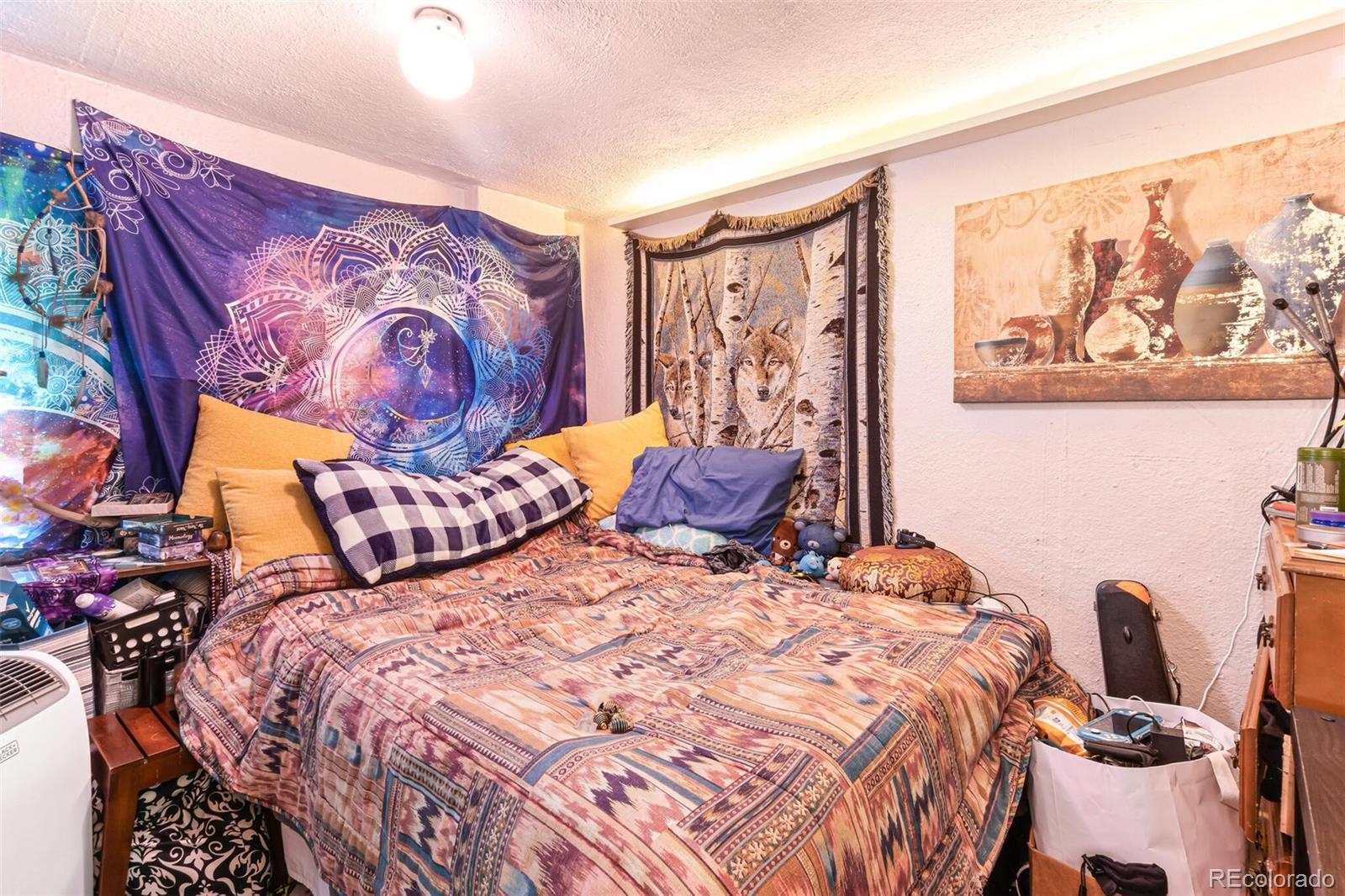 2089 South Logan Street Denver, CO 80210 - Photo 37 of 41 a bedroom with a bed and painting on the wall