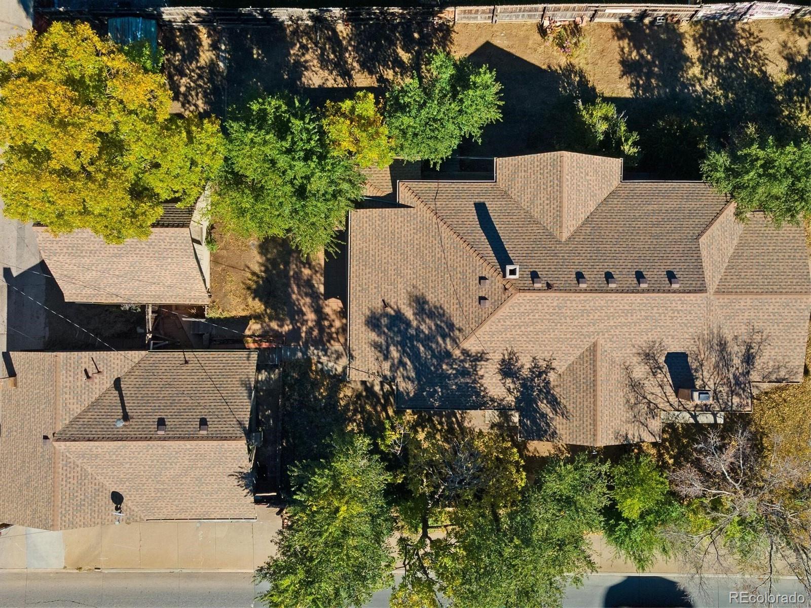 2089 South Logan Street Denver, CO 80210 - Photo 5 of 41 an aerial view of a house with a yard and trees