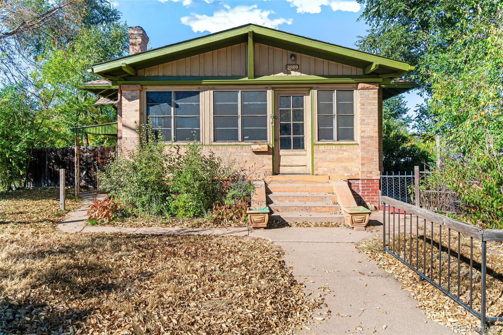 2089 South Logan Street Denver, CO 80210 - Photo 9 of 41 a front view of a house with a yard