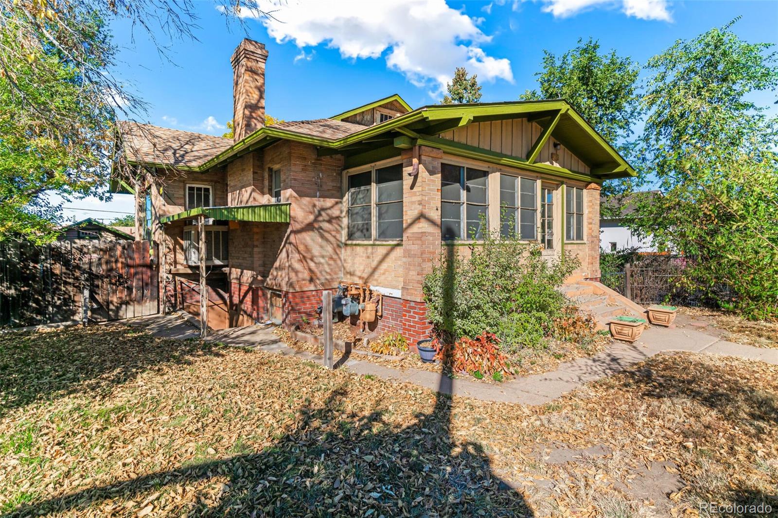 2089 South Logan Street Denver, CO 80210 - Photo 10 of 41 a front view of a house with a yard