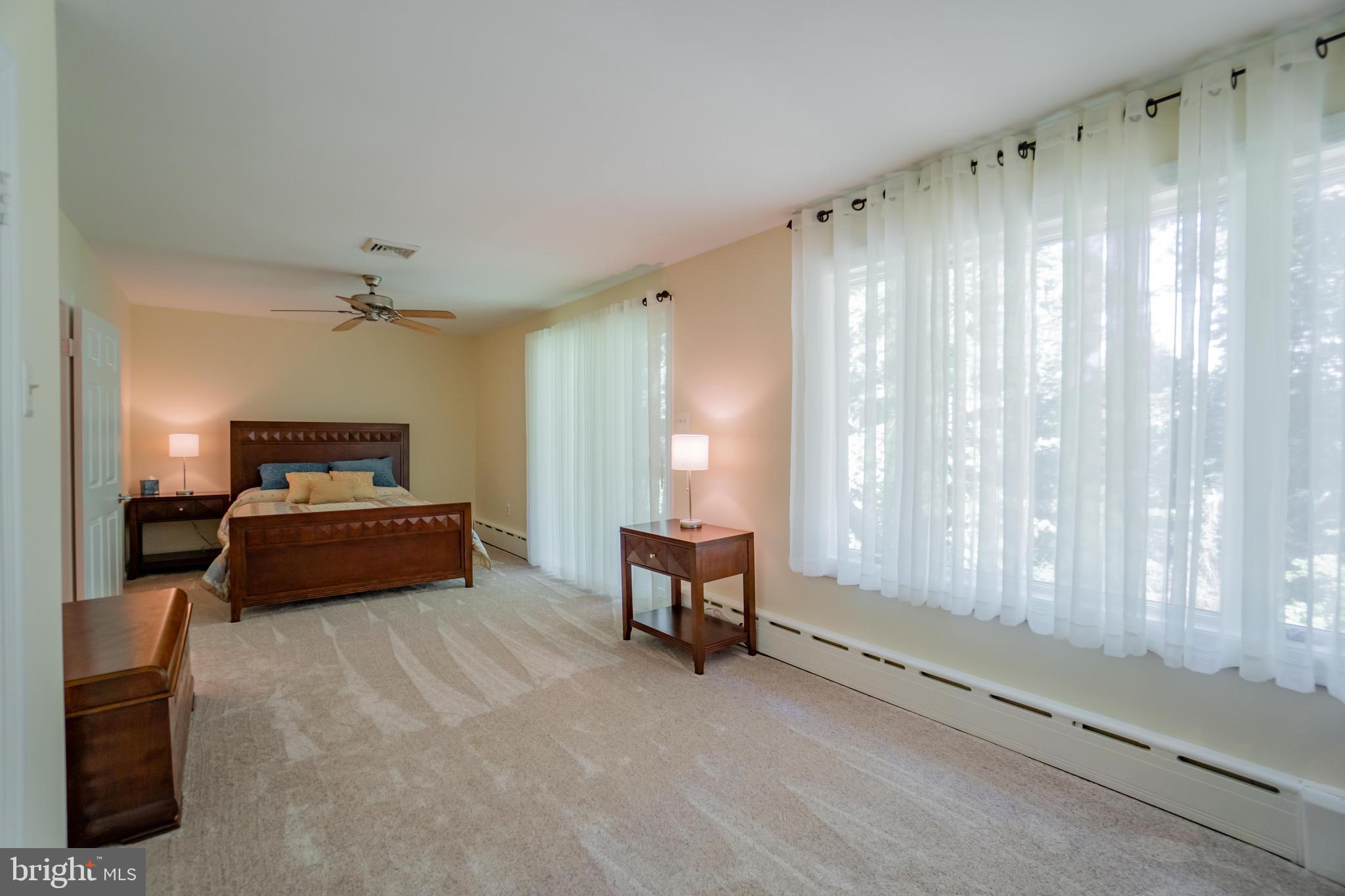 285 Shoemaker Road Huntingdon Valley, PA 19006 - Photo 18 of 46 a bedroom with a bed and a chair