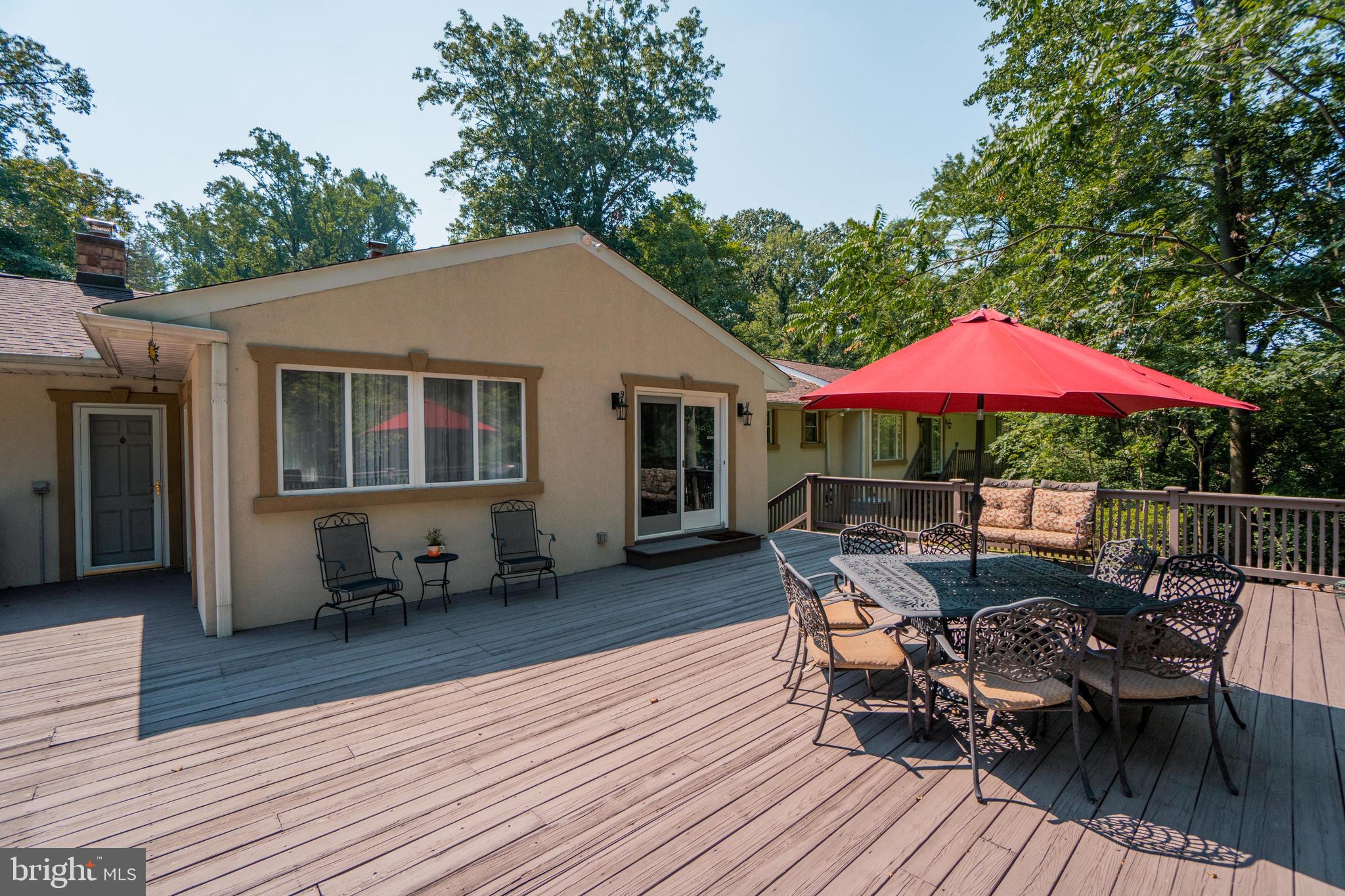 285 Shoemaker Road Huntingdon Valley, PA 19006 - Photo 39 of 46 a patio with wooden floor a yard a table and chairs