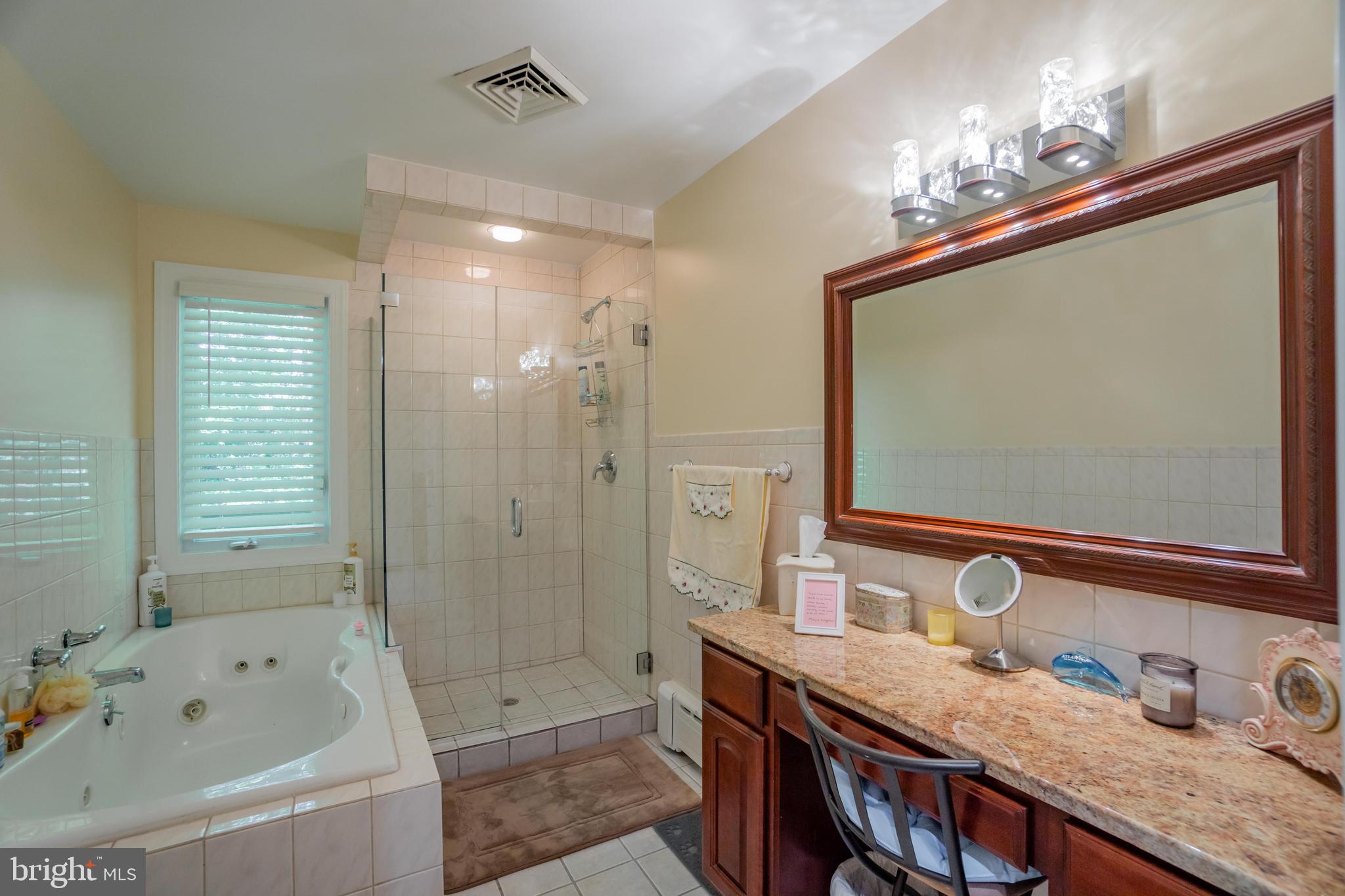 285 Shoemaker Road Huntingdon Valley, PA 19006 - Photo 10 of 46 a bathroom with a tub a sink double vanity and shower