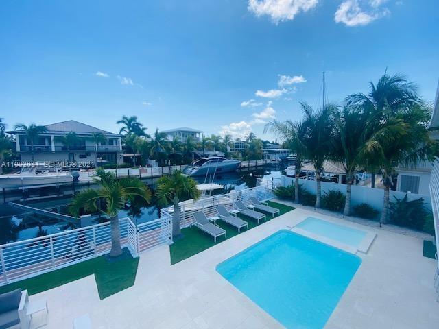 203 Atlantic Boulevard, Unit 203 Key Largo, FL 33037 - Photo 1 of 41 a view of a backyard with sitting area
