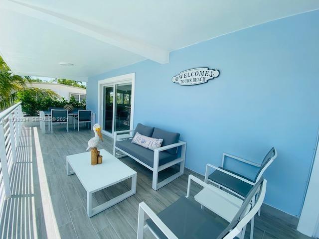 203 Atlantic Boulevard, Unit 203 Key Largo, FL 33037 - Photo 11 of 41 a view of a patio with a table and chairs
