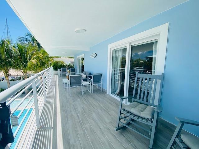 203 Atlantic Boulevard, Unit 203 Key Largo, FL 33037 - Photo 13 of 41 a balcony with table and chairs