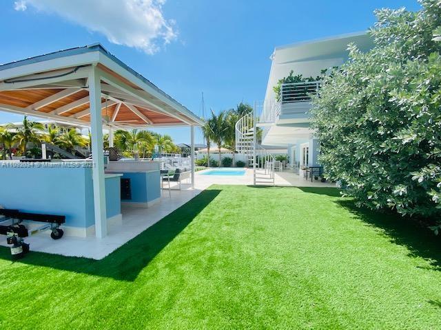 203 Atlantic Boulevard, Unit 203 Key Largo, FL 33037 - Photo 14 of 41 a view of an house with backyard porch and sitting area