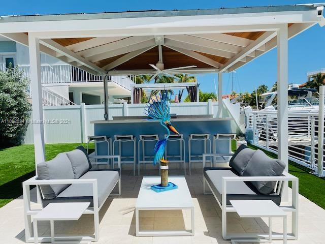 203 Atlantic Boulevard, Unit 203 Key Largo, FL 33037 - Photo 15 of 41 a building outdoor space with patio furniture