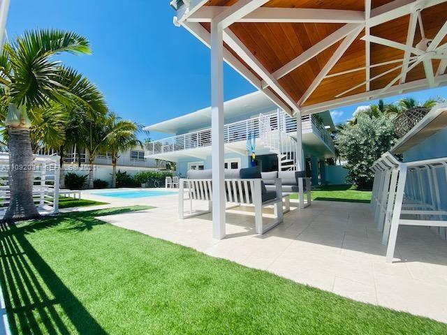 203 Atlantic Boulevard, Unit 203 Key Largo, FL 33037 - Photo 17 of 41 a patio with table and chairs and potted plants