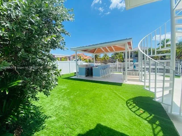 a view of a house with backyard and porch