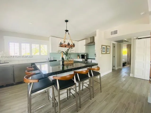 a view of a dining room with furniture wooden floor and chandelier