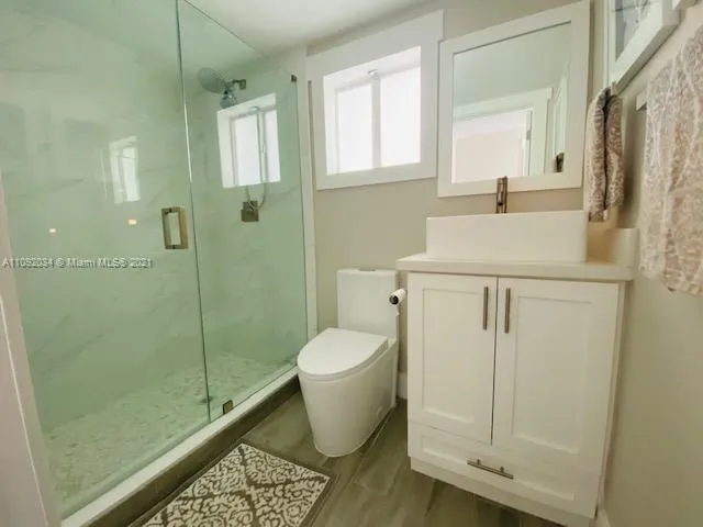 a bathroom with a sink toilet and shower