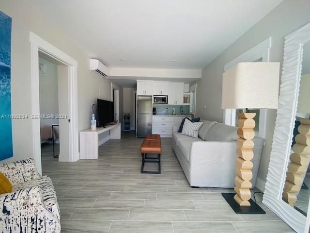 203 Atlantic Boulevard, Unit 203 Key Largo, FL 33037 - Photo 34 of 41 a living room with furniture and a wooden floor